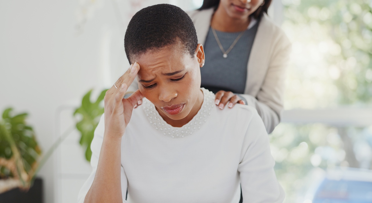 image of black woman experiencing anxiety for article on mental health discrimination in the workplace