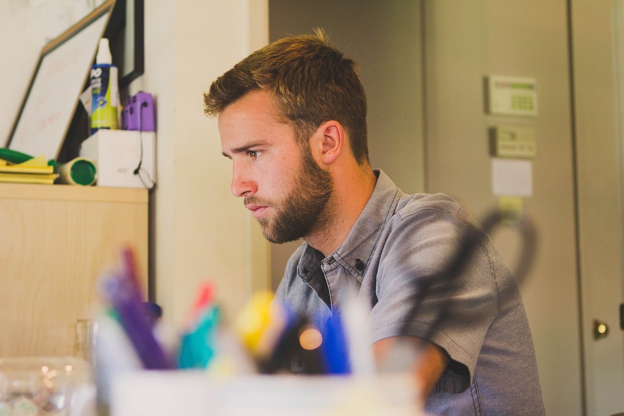 man sitting at desk for article on ai in job market