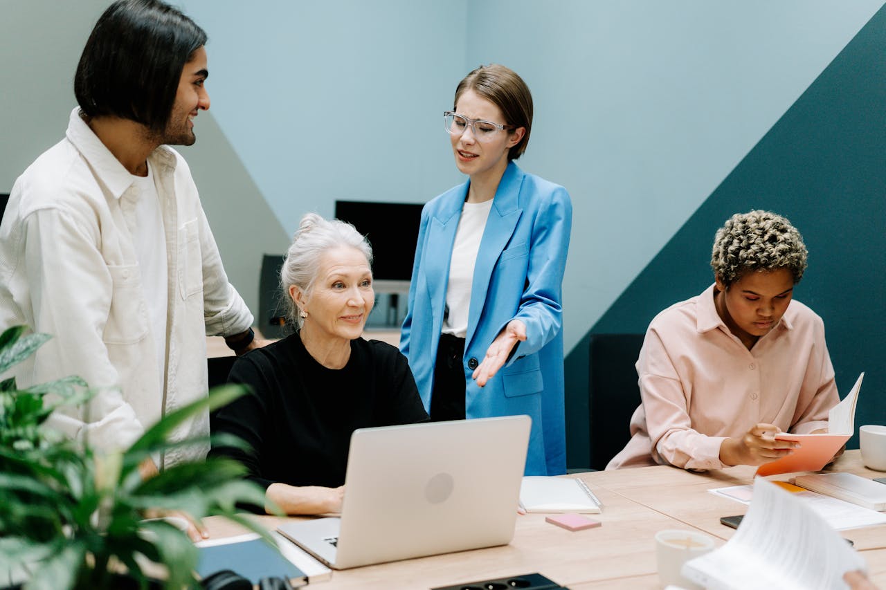 image of team sitting around computer for article on skills gaps